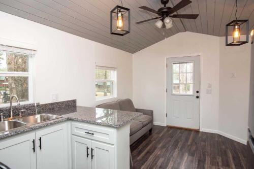 a kitchen with a couch and a ceiling fan at Jellystone Park Tyler in Tyler