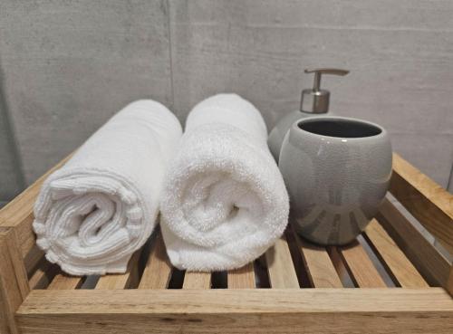 a wooden tray with towels and a sink and a toothbrush at 1884 Aveiro Loft in Aveiro