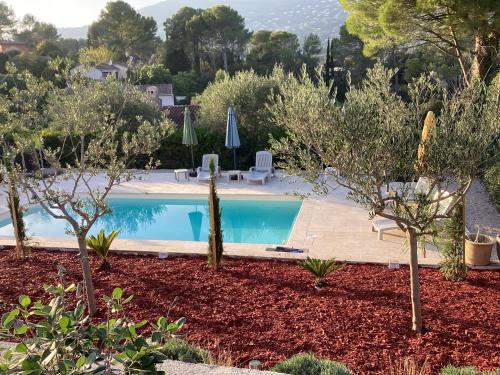 a swimming pool in a garden with trees at Mas Madilauric 2 BNB in Peymeinade