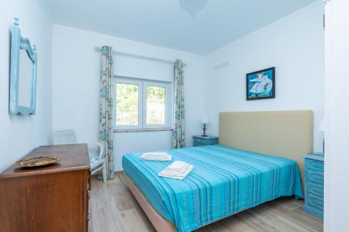 a small bedroom with a bed and a window at Quinta Do Torrejao in Armação de Pêra