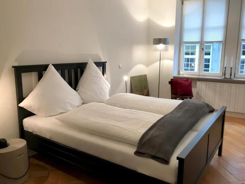 a bedroom with a large bed with a blanket on it at Ferienwohnung Insel-Residenz 1 in Lindau