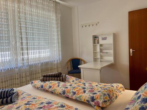 Zimmer mit einem Bett, einem Kühlschrank und einem Fenster in der Unterkunft Ferienwohnung Am Mühlkanal in Langenargen