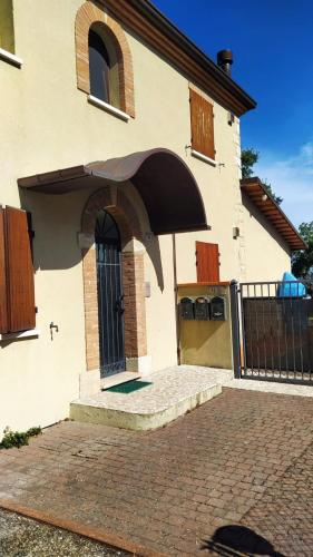 a house with a black door and a brick driveway at Wilsons in Torriana