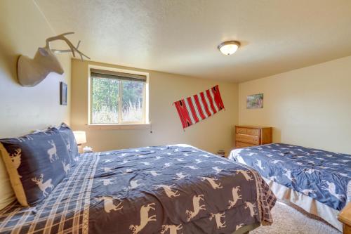 a bedroom with two beds and a window at Custom Log Cabin with Views - 20 Mi to Yellowstone! in Island Park
