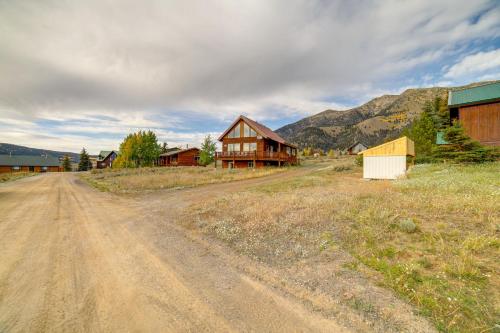 a dirt road in front of a house on a mountain at Custom Log Cabin with Views - 20 Mi to Yellowstone! in Island Park