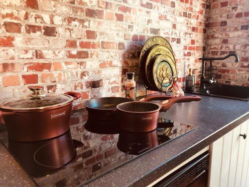 a kitchen counter with two pots on a stove at Slapen bij de Brug in Zuidveld