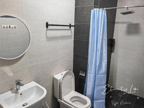 a bathroom with a toilet and a sink and a mirror at Troika Residence Kota Bharu @ Eternity Live-1B4pax in Kota Bharu