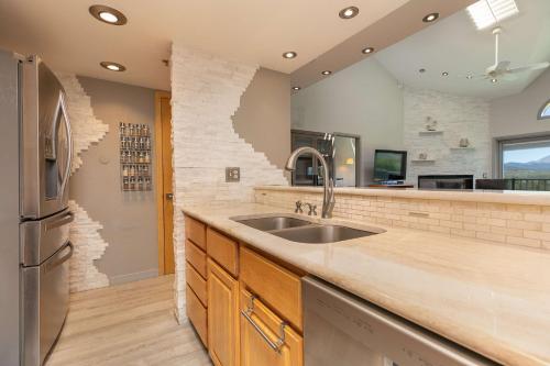 a kitchen with a sink and a refrigerator at Lake Forest Lakeview Long Stay Condo: Fantastic Location, Views in Frisco