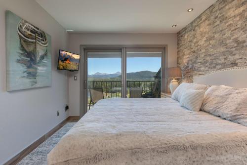 a bedroom with a large bed and a balcony at Lake Forest Lakeview Long Stay Condo: Fantastic Location, Views in Frisco