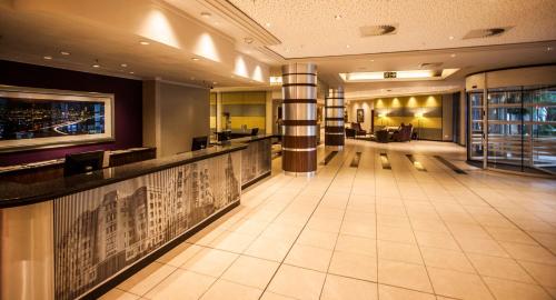 a lobby of a hotel with a bar at Garden Court Sandton City in Johannesburg