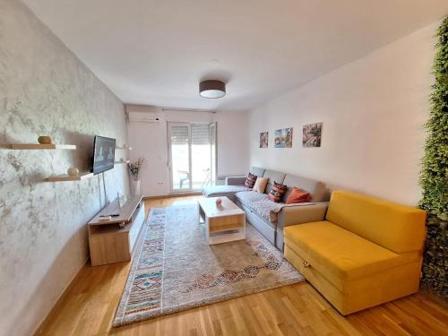 a living room with a couch and a table at Apartman Cherine in Mostar