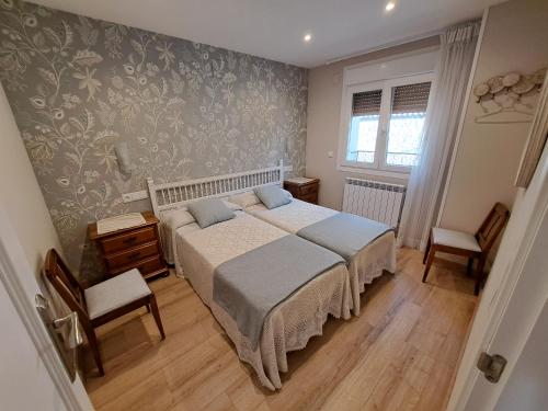 Postel nebo postele na pokoji v ubytování APARTAMENTO CASA COTI