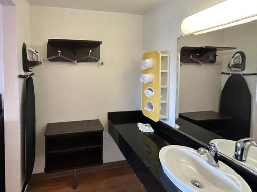 a bathroom with a sink and a mirror at Studio 6 Suites - Riverside, CA South in Riverside