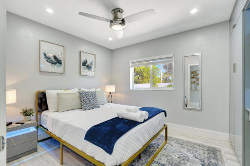 a bedroom with a bed and a window at The Gardens - Luxury Retreat with Pool & Game Room in Miami Gardens