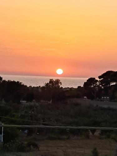 a sunset over the ocean with the sun in the sky at La Foggia seaside paradise in Siculiana