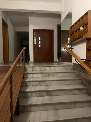 an empty hallway with stairs and a door at ONE OF THE CHEAPEST IN THE CITY Eucalyptus in Komotini