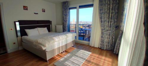 a bedroom with a bed and a large window at Luxury apartment in Istanbul