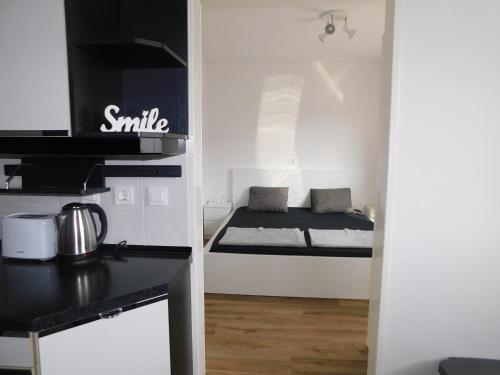 a small white room with a small bed in it at Elegant Apartment Poklukarjeva Street in Ljubljana