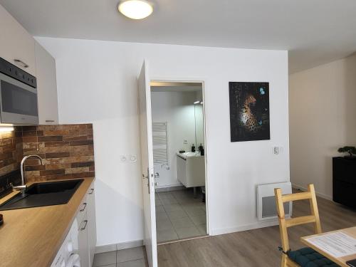 a kitchen with a sink and a counter top at Studio cosy à 5 minutes de DISNEYLAND PARIS in Chalifert