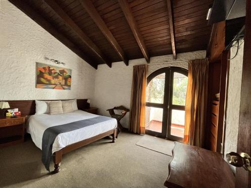Tempat tidur dalam kamar di Hotel La Casa de Tin tin