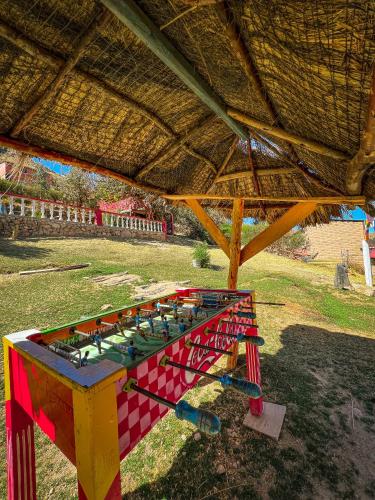a colorful table withools on it in a field at Hostal Sol y Lago in Copacabana