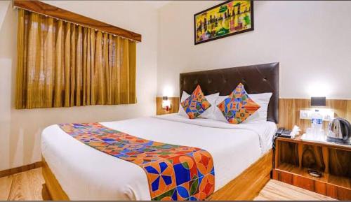 a bedroom with a large bed in a room at Deluxe Residency Nr- Mumbai International Airport in Mumbai