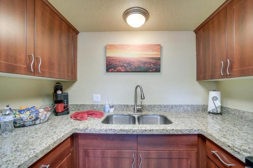 a kitchen with a sink and wooden cabinets at The Painted Pony Condo with Pool and Gym Access! in Sedona
