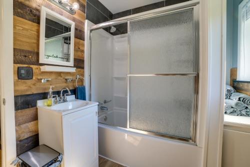 a bathroom with a shower and a sink at Higgins Lake Cottage with Private Fire Pit and Grill! in Roscommon