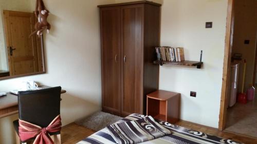 a bedroom with a chair with a bow on it at Guest House Dara in Tsarevo