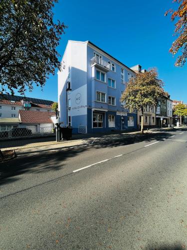 a white building on the side of a street at Designhotel Central Fulda in Fulda