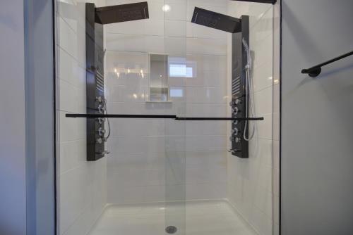 a glass shower stall with a glass door with a sink at Salty Kisses - Let The Beach Reconnect Your Souls in Corolla