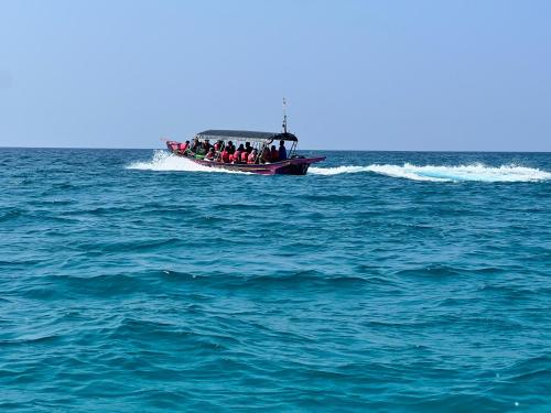 a group of people on a boat in the ocean at Perhentian Mama's in Perhentian Island