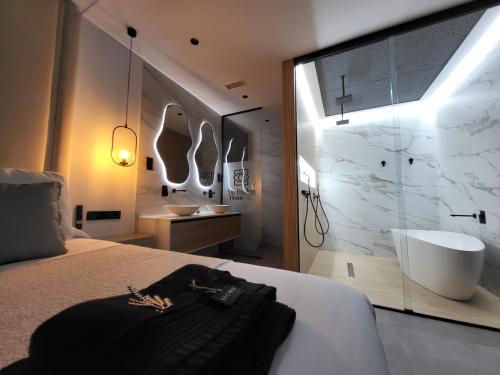 a bedroom with a bathroom with a tub and a sink at suites home ruidera in Ruidera