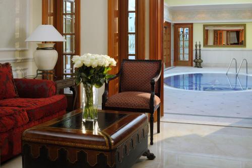 a living room with a couch and a swimming pool at Connaught Palace Hotel, Dubai in Dubai