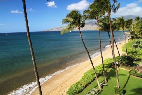 a view of a beach with palm trees and the ocean at KIHEI BEACH, #506^ condo in Kihei