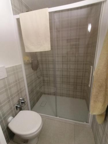 a bathroom with a toilet and a glass shower at La casa di Trilly in Sanremo
