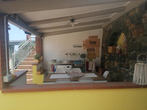 a kitchen with a table and chairs in a room at La casa di Trilly in Sanremo