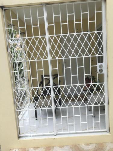a door with a white gate in a room at Apartment in Montego Bay, St James - Fully Equipped For Long Term Stays in Montego Bay