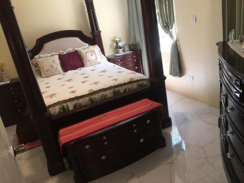 a bedroom with a bed with a large mirror at Apartment in Montego Bay, St James - Fully Equipped For Long Term Stays in Montego Bay
