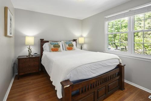 a bedroom with a large bed and a window at Townhome in No VA, 40 Mins to DC, Pets OK, Fast WiFi in Sterling