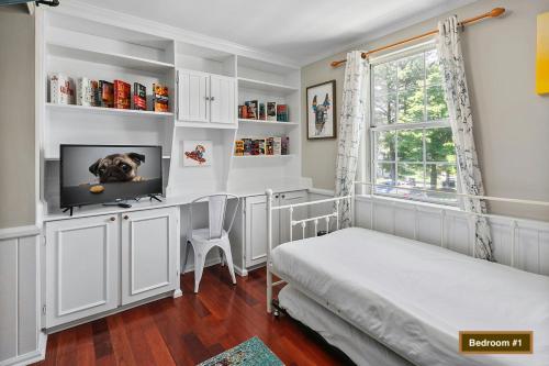 a bedroom with a bed and a tv in it at TH in No VA, 40 Mins to DC, Pets OK, Fast WiFi in Sterling