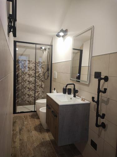 a bathroom with a sink and a toilet and a shower at Loft Porta Sud Civ.33 in Brindisi