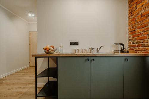 a kitchen with a counter and a brick wall at Old brick boutique apartments in Klaipėda
