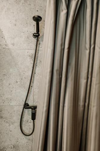 a shower in a bathroom with a shower curtain at Old brick boutique apartments in Klaipėda