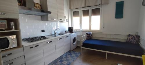 a small kitchen with a sink and a stove at Casatua in Taranto
