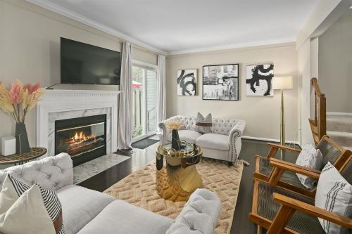 a living room with a fireplace and a tv at Sleeps 6, Nature trails, 40 Mins to DC, 2 cars MAX in Sterling