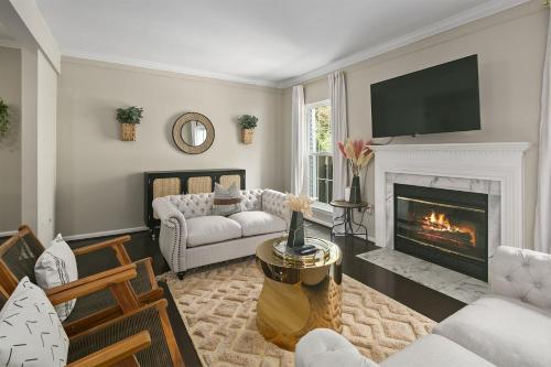 a living room with a fireplace and a tv at Sleeps 6, Nature trails, 40 Mins to DC, 2 cars MAX in Sterling