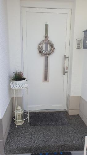 a cross on the front door of a white door at Ferienwohnung Pees in Baumholder