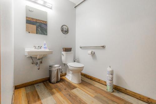 a bathroom with a toilet and a sink at Pintler's Portal Hostel in Anaconda