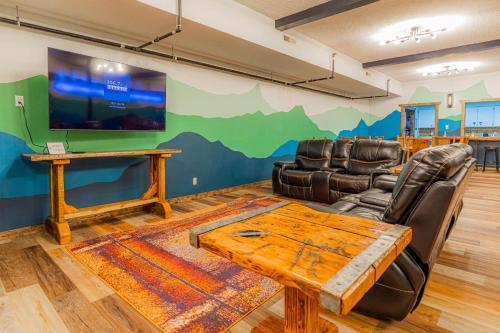 a living room with a table and a tv at Pintler's Portal Hostel in Anaconda